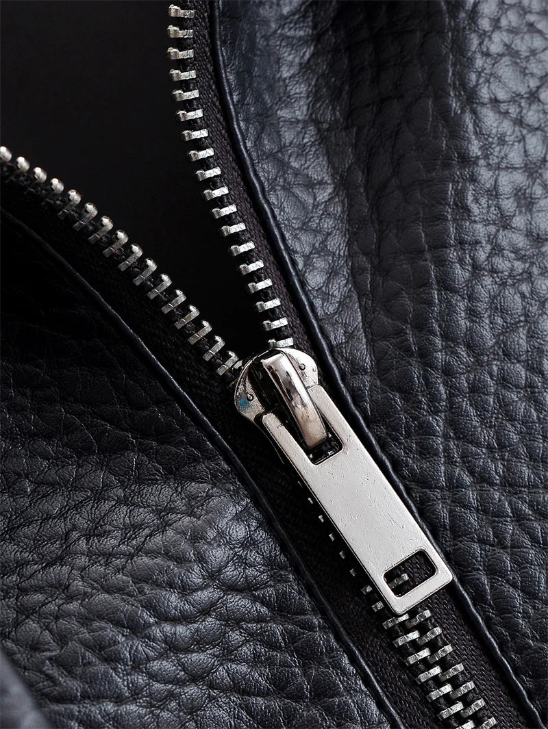 Close-up of a black leather jacket with a silver zipper