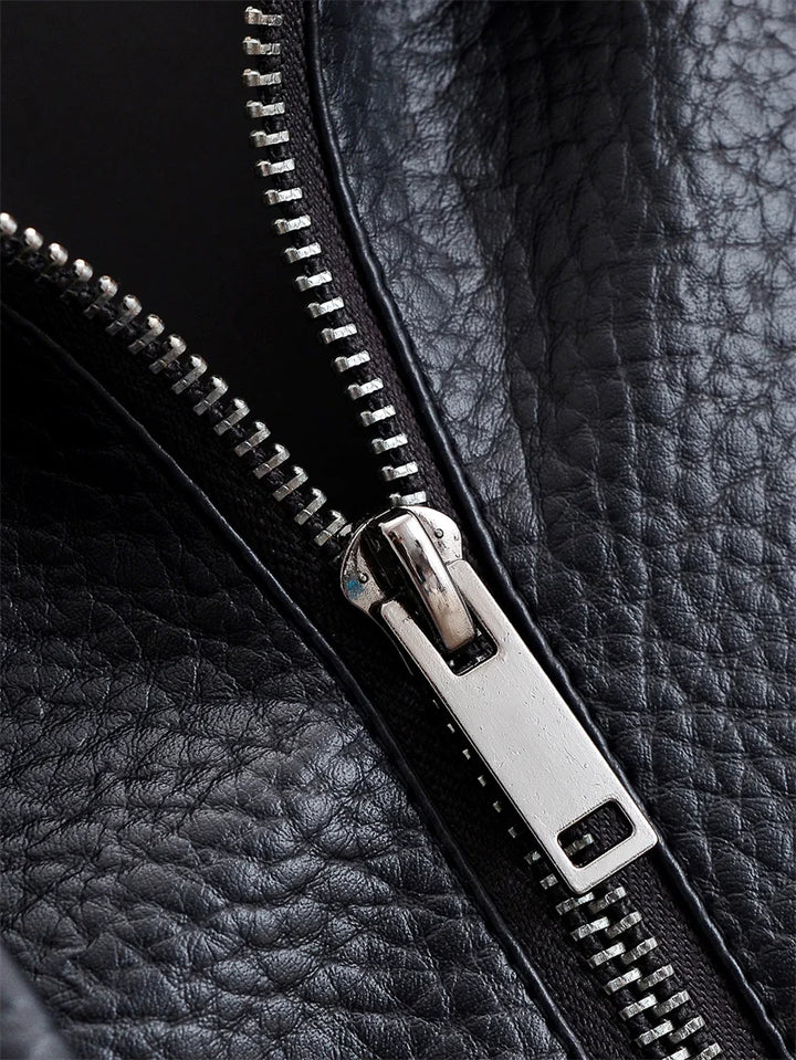 Close-up of a black leather jacket with a silver zipper