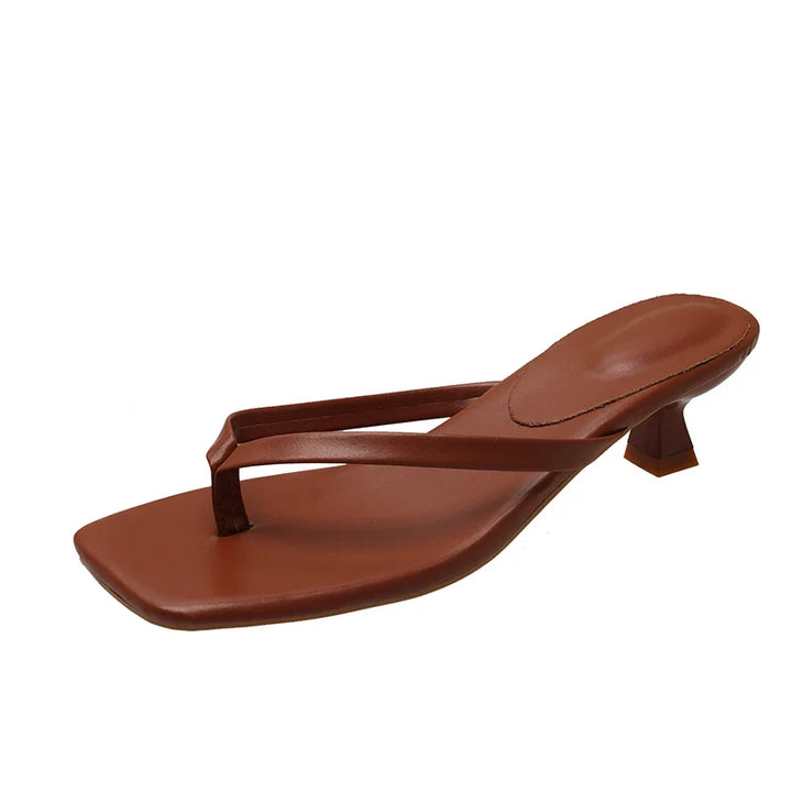 Brown sandal with a small heel on a white background