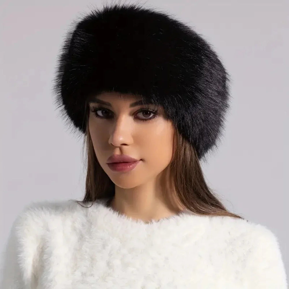 Woman wearing a black fur hat against a gray background