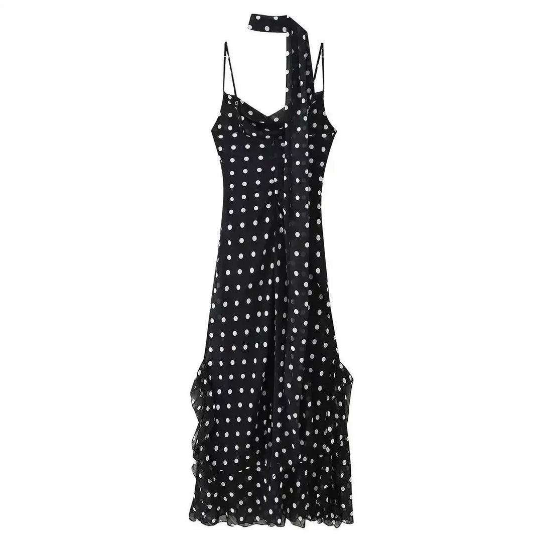 Black dress with white polka dots on a white background