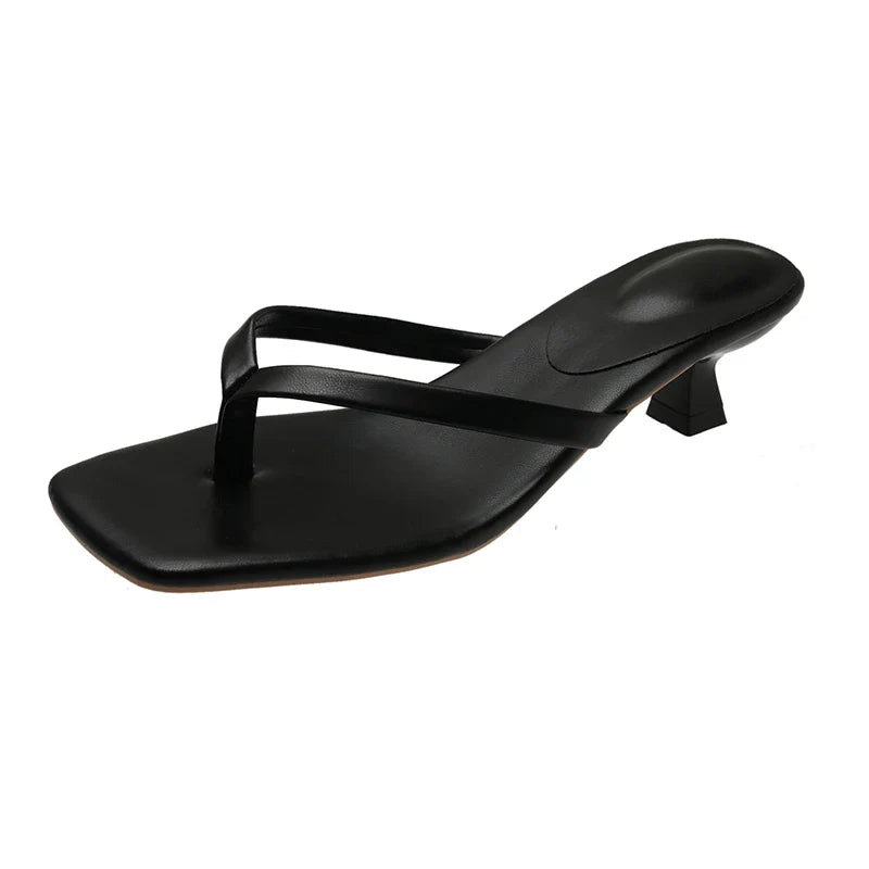 Black sandal with a small heel on a white background