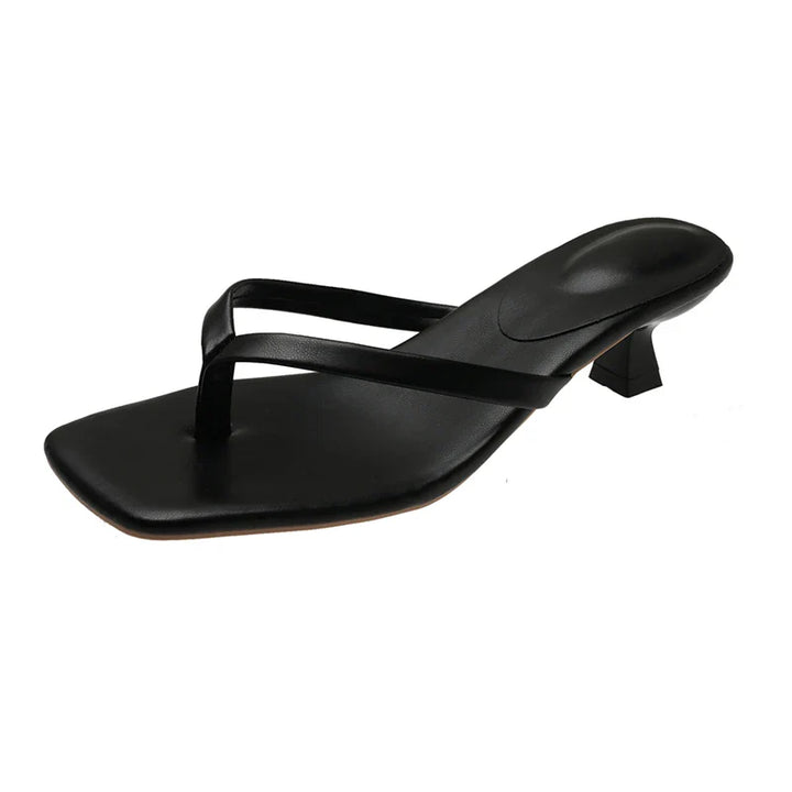 Black sandal with a small heel on a white background