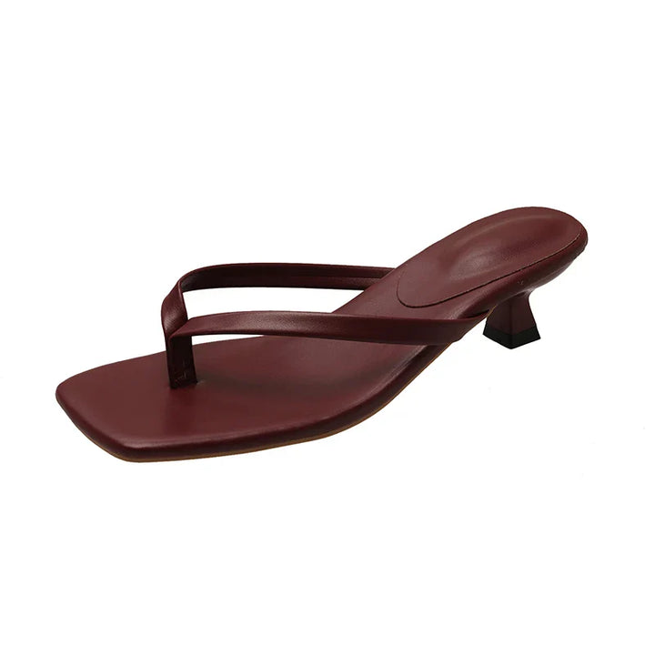 Brown sandal with a high heel on a white background