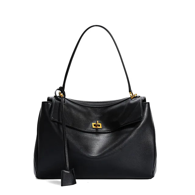 Black handbag with a gold clasp on a white background
