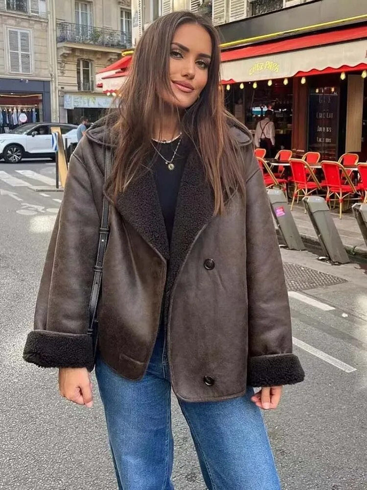 Woman wearing a brown shearling jacket on a city street